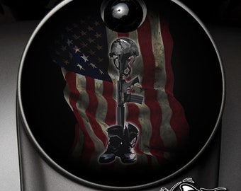 May include: A black and white image of a fallen soldier memorial. The image features a military helmet, rifle, and boots against a backdrop of an American flag.
