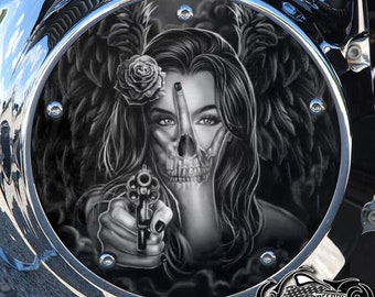 May include: Black and white illustration of a woman with a skull face holding a gun. She is wearing a flower in her hair and has angel wings behind her. The image is on a round, black background.