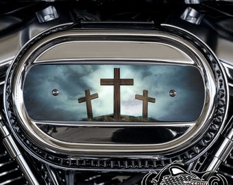 May include: Chrome motorcycle air cleaner cover with a graphic of three wooden crosses against a stormy sky.