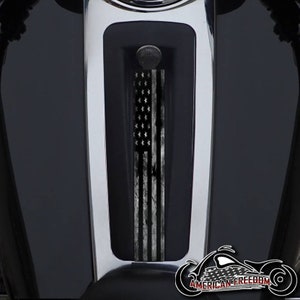 May include: A black and white distressed American flag decal for a motorcycle gas tank. The decal is in a vertical orientation and has a distressed look. The decal is placed on a black motorcycle gas tank.