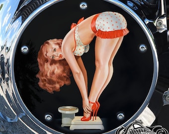 May include: A pinup girl in a red and white polka dot bikini stands on a scale with a black background. The scale is white with a silver base. The pinup girl has red hair and is wearing red high heels.