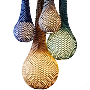 May include: Four teardrop-shaped pendant lights made of woven material in shades of blue, green, and brown.