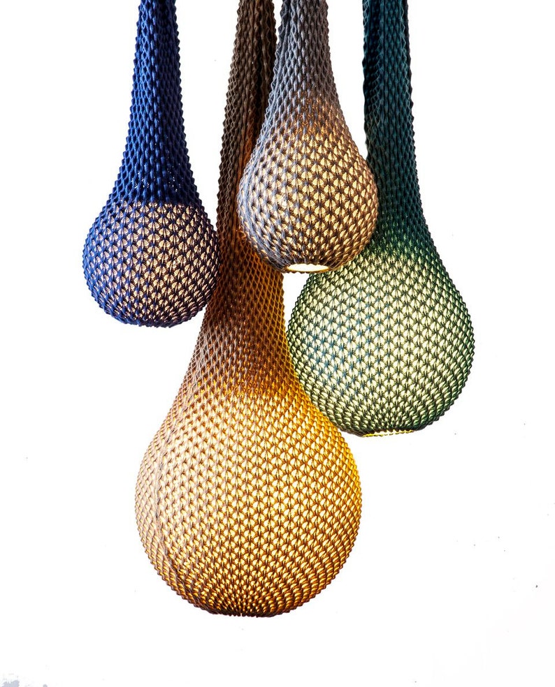 May include: Four teardrop-shaped pendant lights made of woven material in shades of blue, green, and brown.