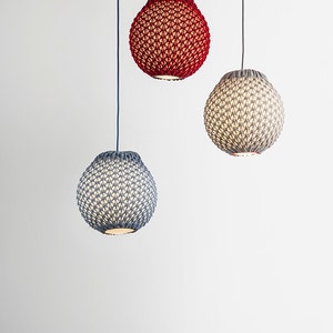 May include: Three hanging light fixtures with knitted shades. The shades are red, gray, and blue.