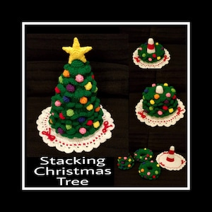 May include: A set of crocheted Christmas tree ornaments. The ornaments are green with red and white trim and feature a yellow star on top. The ornaments are stacked on top of each other to create a Christmas tree. The text "Stacking Christmas Tree" is written below the ornaments.