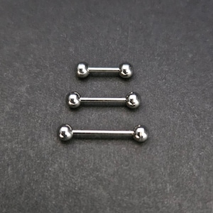 May include: Three silver barbell-style body jewelry pieces. Each piece has a straight bar with a ball on each end. The jewelry is displayed on a dark gray surface.