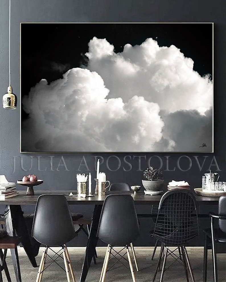 Large black and white painting, hanging in a modern dining room.