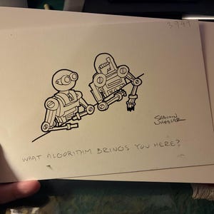 May include: A black and white ink drawing on off-white paper featuring two robots. The text reads, "WHAT ALGORITHM BRINGS YOU HERE?" and is signed "SHANNON WHEELER" with the number "3949" in the top right corner of the rectangular paper.