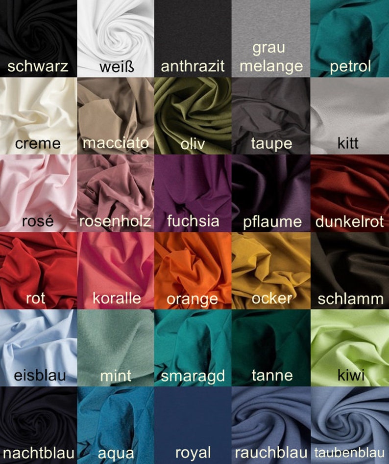 May include: Swatch card displaying 25 different fabric colours, including black, white, grey, red, blue, green, and yellow. The colours are arranged in a grid pattern and labelled with their German names.