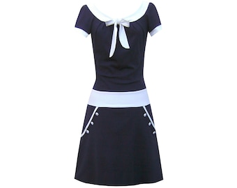 Two-tone navy dress with round neckline, beautiful bow, decorative buttons, flared A-line silhouette, available in many colors.