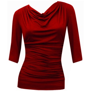 May include: A red, long-sleeved, cowl neck top with a fitted silhouette.