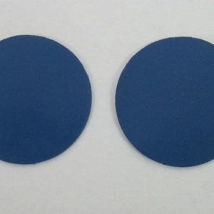 Pode incluir: Dois  apoios de copo redondos, de feltro azul.