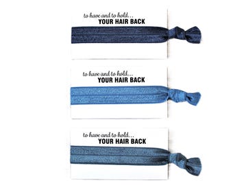 May include: Three blue hair ties with the text "to have and to hold... YOUR HAIR BACK" printed on white cards.