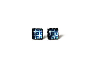 May include: A pair of square-shaped earrings with a blue and white geometric pattern.