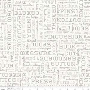 May include: White fabric with a gray pattern of sewing-related words and phrases, such as "sew happy", "patchwork", "scissors", "thread", "pins", "measure", "embroidery", "hook", "button", "applique", "quilt", "fabric", "knit", "crochet", "spool", "yarn", "needle", "press", "ruler", "stitch", "cut", "create", "pincushion", "made with love", "add a touch", "my happy place", and "tools".