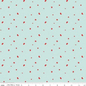 May include: A light blue fabric with a repeating pattern of red and white mushrooms. The fabric is perfect for crafting projects like quilts, pillows, and bags.