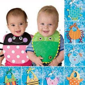 May include: A Simplicity sewing pattern for making baby bibs with various animal designs, including a ladybug, frog, turtle, crab, bear, bee, and a striped bib. The pattern number is 2468.