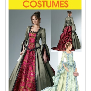 May include: McCall's Costumes pattern showing three period gowns. The dresses are in olive green, burgundy, and pale yellow, with detailed floral designs and lace edging. The image includes a woman wearing a green and pink gown.