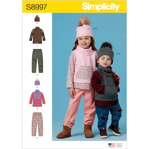 May include: Simplicity pattern S8997 for children's clothing. The image shows two children wearing outfits made from the pattern. The outfits include a pink floral top, pink trousers, a grey vest, and a grey beanie with a pom-pom. The pattern also includes a jacket and trousers.
