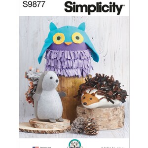 May include: A sewing pattern for making three plush toys: an owl, a hedgehog, and a porcupine. The pattern is from Simplicity and is easy to sew. The owl is purple with blue wings and yellow eyes. The hedgehog is gray with brown quills. The porcupine is white with brown quills.