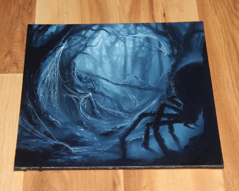 May include: A square canvas painting depicting a dark, monochromatic blue forest scene. A large, silhouetted spider is positioned on the right side, with intricate white spiderwebs stretching across the gnarled tree branches in the center.