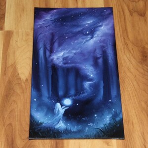 May include: A rectangular canvas painting featuring a dark forest scene in shades of blue and purple. A figure stands in the foreground holding a glowing white orb, from which a swirling mist rises into the starry night sky above the trees.