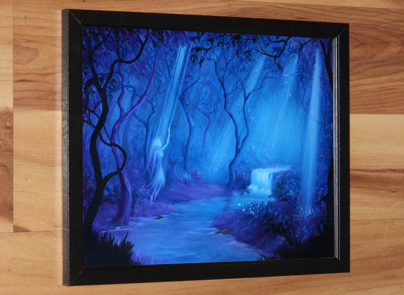 May include: Framed painting of a mystical forest scene. The artwork features a flowing river, a small waterfall, and ethereal figures bathed in blue and purple hues. The painting is set in a black frame.