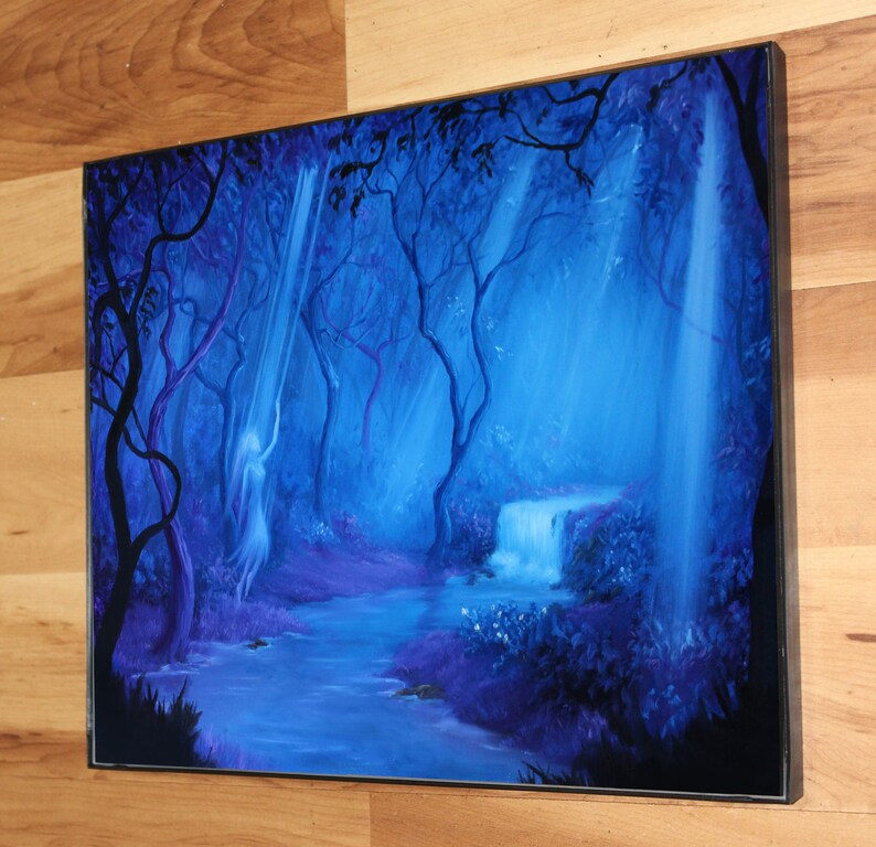 May include: A framed painting depicts a mystical forest scene. The artwork features a waterfall, a flowing river, and a spectral figure, all bathed in shades of blue and purple. The trees and foliage create a sense of depth and tranquility.
