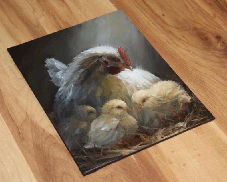May include: An oil painting depicts a white hen with a red comb, sheltering three yellow chicks in a nest of straw. The hen's feathers are detailed with shades of gray and white, creating a soft, realistic texture. The artwork is set against a dark background.