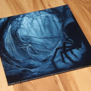 May include: A square canvas painting featuring a dark, monochromatic blue forest scene. The artwork depicts a dense thicket of trees with intricate, glowing white spiderwebs stretching between branches and a large, dark spider silhouette on the right.