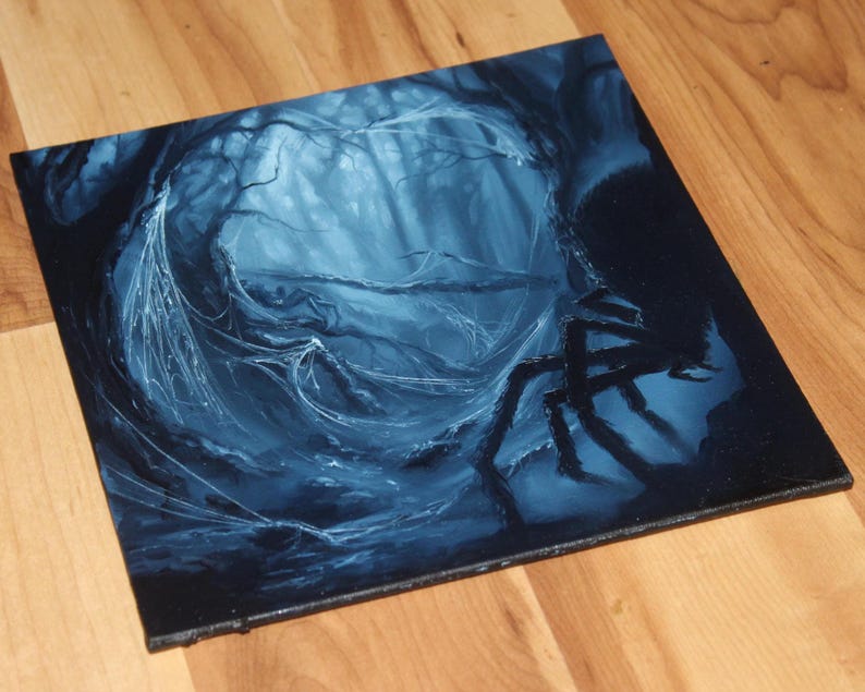 May include: A square canvas painting featuring a dark, monochromatic blue forest scene. The artwork depicts a dense thicket of trees with intricate, glowing white spiderwebs stretching between branches and a large, dark spider silhouette on the right.