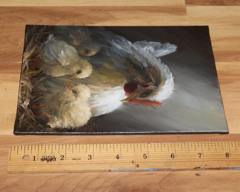 May include: An oil painting depicts a hen with three chicks in a nest. The hen has white and gray feathers, a red comb, and a yellow beak. The chicks are fluffy and yellow. The painting is on a rectangular canvas.