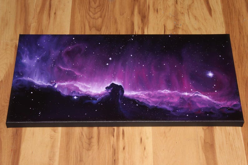 May include: A rectangular canvas print depicting a vibrant nebula in shades of purple, pink, and black. The artwork features a celestial scene with stars and a prominent Horsehead Nebula formation. The canvas is stretched on a black frame.
