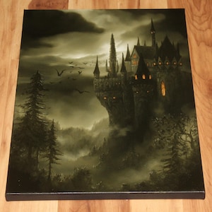 May include: A canvas print depicting a gothic castle on a cliff, illuminated by warm light from within. The artwork features a dark, moody color palette with a cloudy sky, silhouetted trees, and flying birds, creating a mysterious atmosphere.