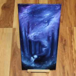 May include: A rectangular canvas painting featuring a dark forest scene in shades of deep blue and purple. A figure stands in the foreground holding a glowing white orb, with swirling cosmic clouds and scattered stars filling the night sky above.