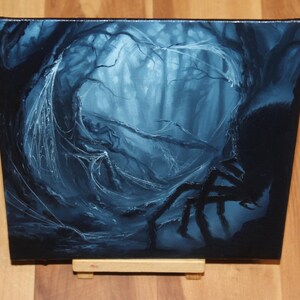 May include: A square canvas painting depicting a dark, monochromatic blue forest scene. The artwork features a large, silhouetted spider in the foreground with intricate, glowing white spiderwebs draped across twisted tree branches in the background.