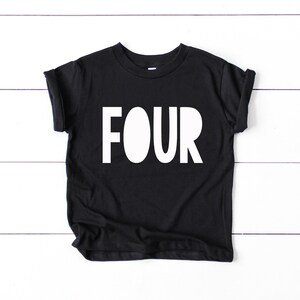 May include: Black t-shirt with white text that says "FOUR" on it.