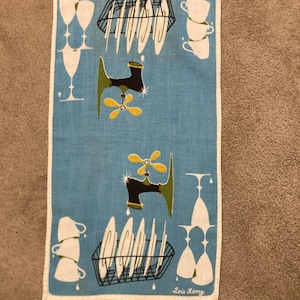 May include: A rectangular light blue kitchen towel featuring a white border and a repeating graphic print of black dish racks, white plates, white cups, white wine glasses, and black faucets with yellow handles. The name Lois Long is printed in white.