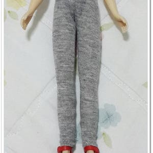 May include: Grey leggings for a doll with red shoes.