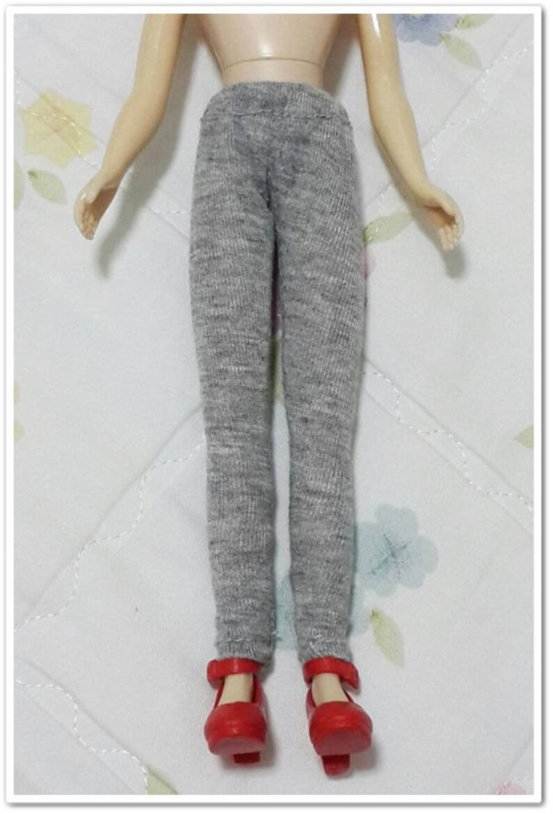 May include: Grey leggings for a doll with red shoes.