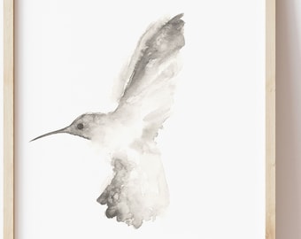 May include: A watercolor painting of a hummingbird in flight. The bird is depicted in shades of gray against a white background.