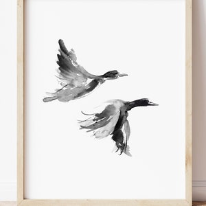 May include: Black and white watercolor painting of two ducks in flight. The ducks are painted in a minimalist style with simple lines and shapes.