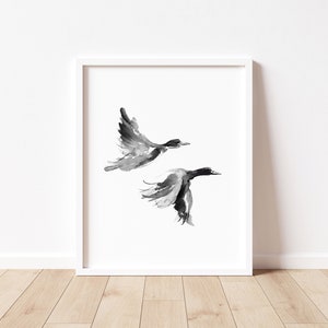 May include: A black and white watercolor painting of two birds in flight. The birds are painted in a minimalist style, with simple lines and shapes.