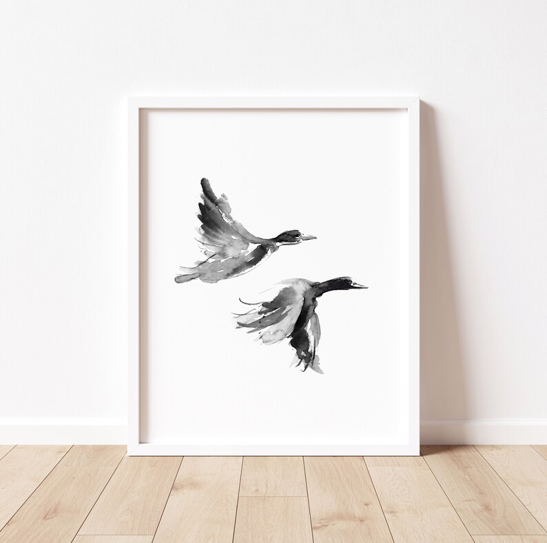 May include: A black and white watercolor painting of two birds in flight. The birds are painted in a minimalist style, with simple lines and shapes.