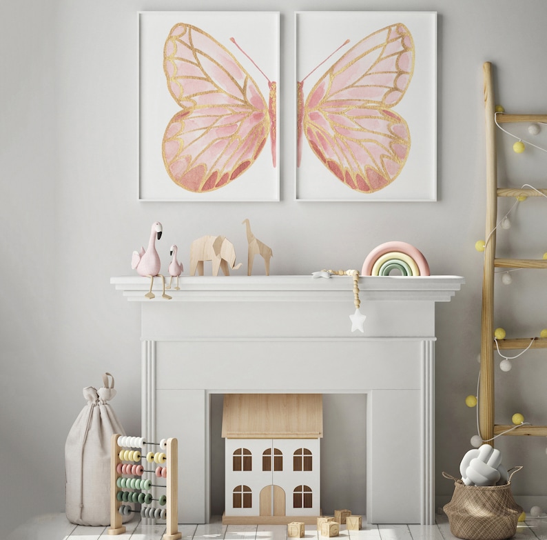 May include: A white fireplace mantel with a pink and gold butterfly print above it. There are pink flamingo figurines, a wooden dollhouse, and a rainbow-colored wooden arch on the mantel.