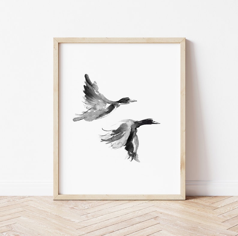 May include: Black and white watercolor painting of two ducks in flight. The ducks are painted in a minimalist style with simple lines and shapes.
