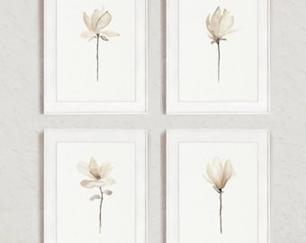Könnte beinhalten: Set aus vier gerahmten Drucken mit Aquarell-Illustrationen von Magnolienblüten in Beige- und Brauntönen.