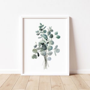 May include: A watercolor painting of a bouquet of eucalyptus leaves in shades of green and blue. The leaves are arranged in a loose, natural style, and the painting has a simple, elegant feel.