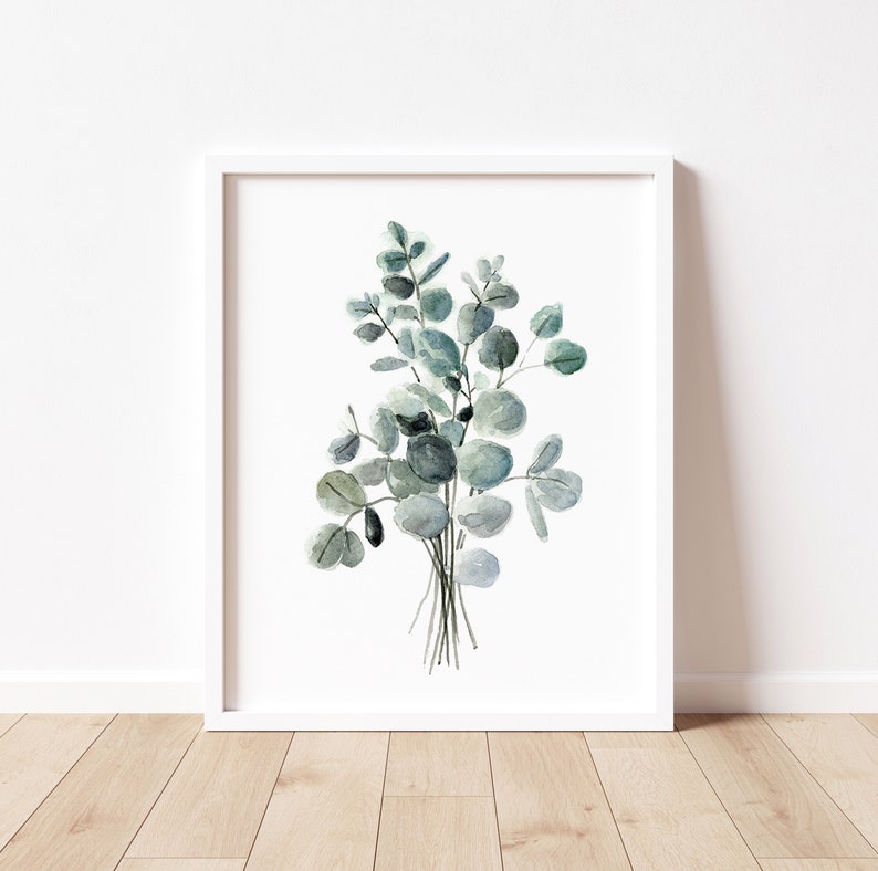 May include: A watercolor painting of a bouquet of eucalyptus leaves in shades of green and blue. The leaves are arranged in a loose, natural style, and the painting has a simple, elegant feel.