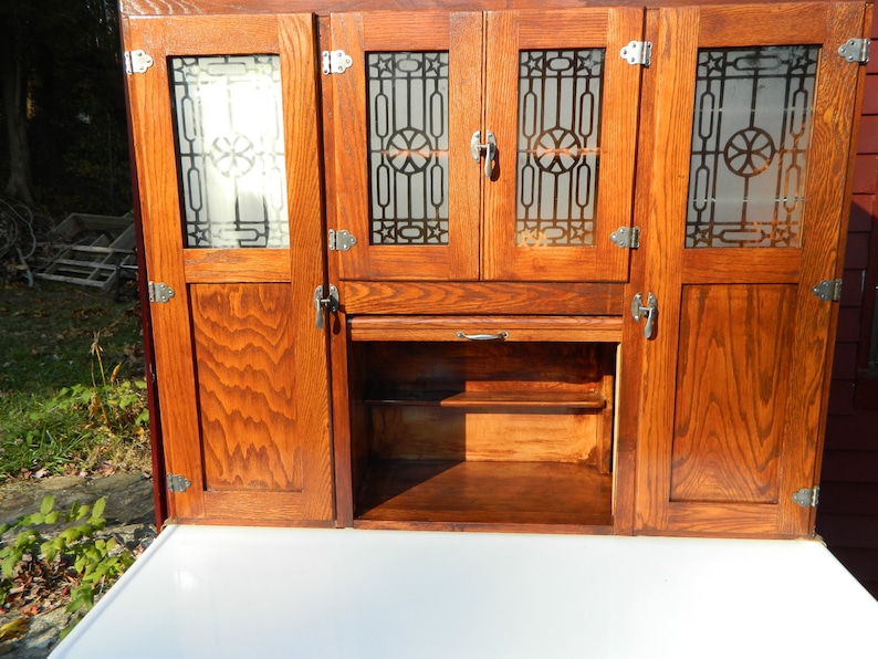 1920's Montgomery Wards Oak Hoosier Cabinet with etched image 0